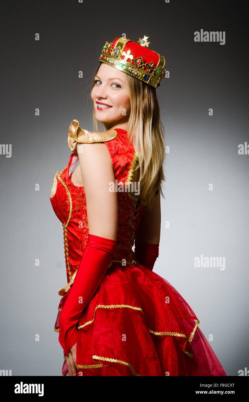 Queen in red costume against dark background Stock Photo - Alamy