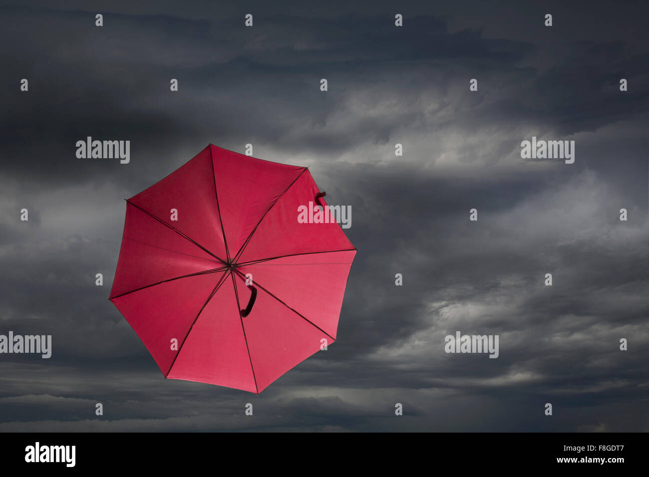 Red umbrella blowing in storm Stock Photo Alamy
