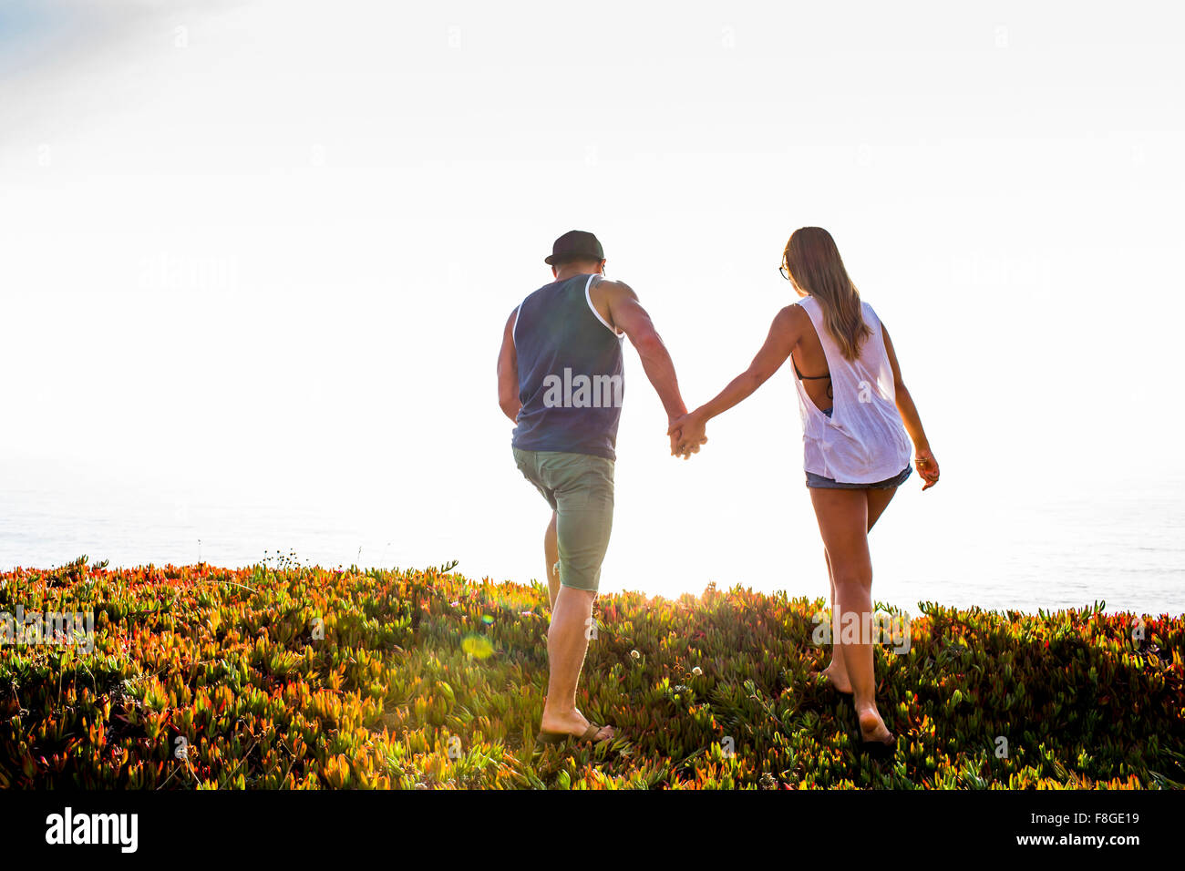 Caucasian couple holding hands outdoors Stock Photo