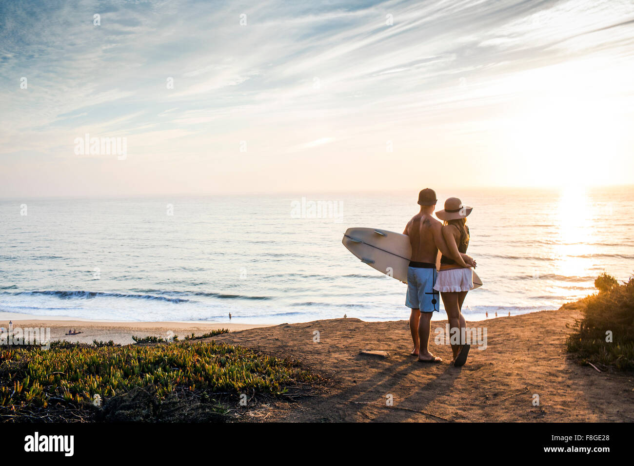 Caucasian couple admiring seascape at beach Stock Photo