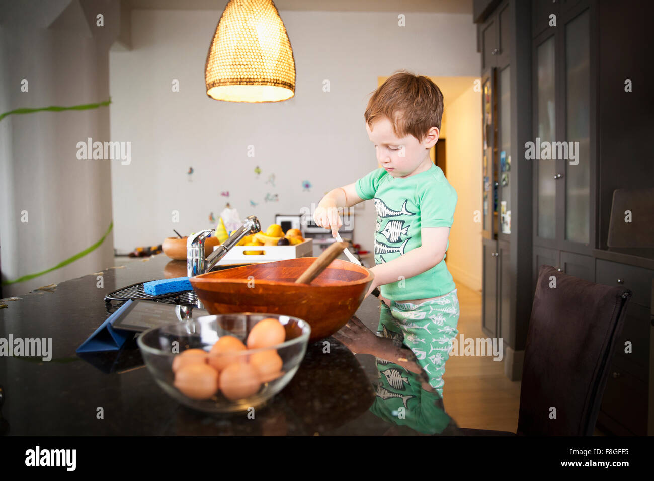 Boy cooking in kitchen Stock Photo