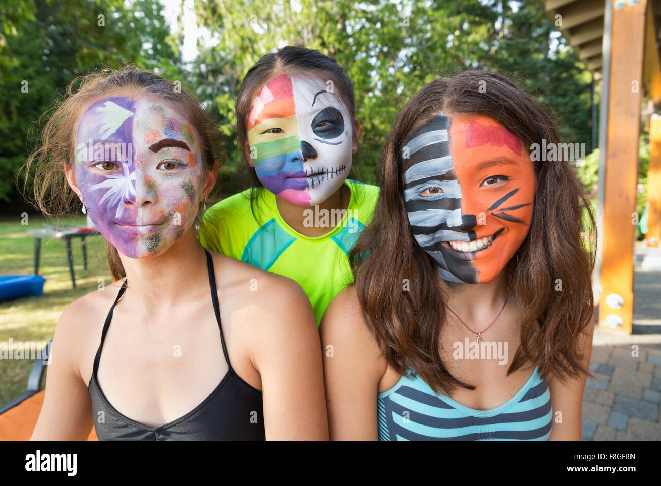 Smiling girls wearing face paint Stock Photo
