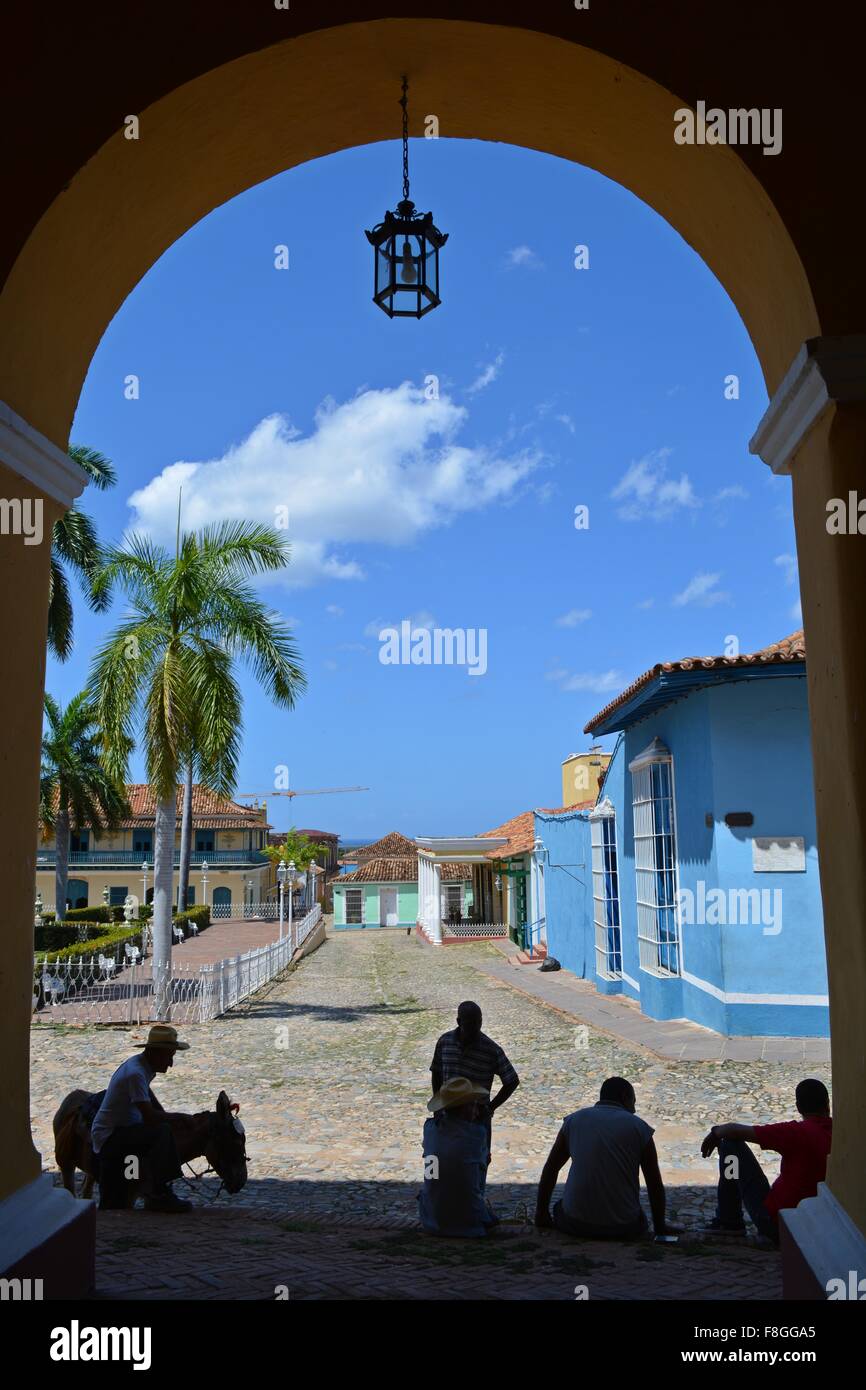 local men with horse sat in the shade of the Plaza Mayor in historic Trinidad Sancti Spiritus Province Cuba Stock Photo
