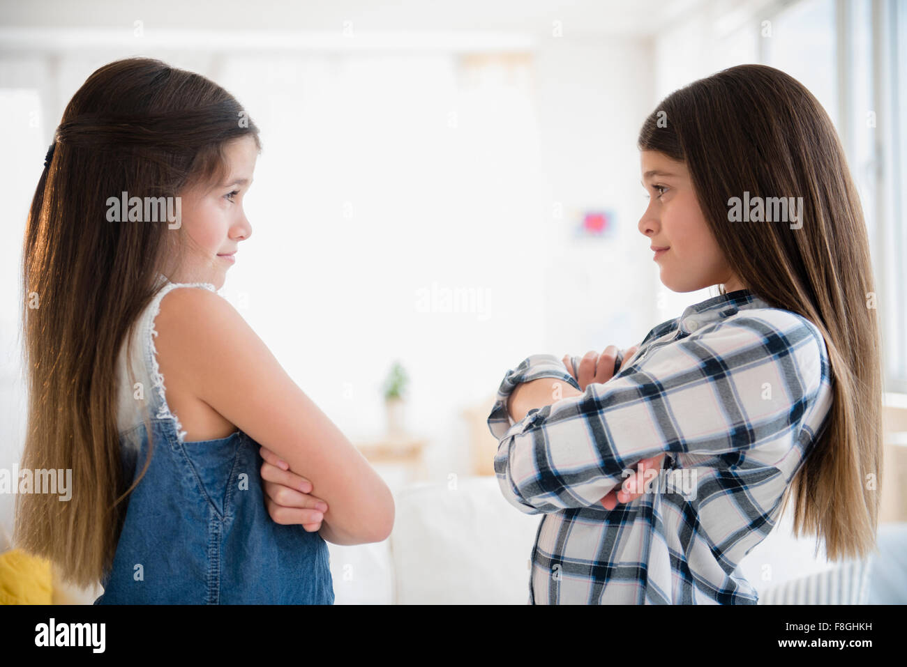 Caucasian twin sisters arguing Stock Photo