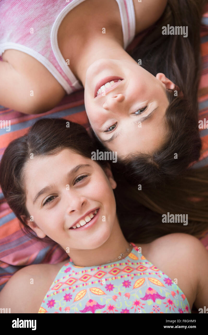 Caucasian twin sisters smiling Stock Photo