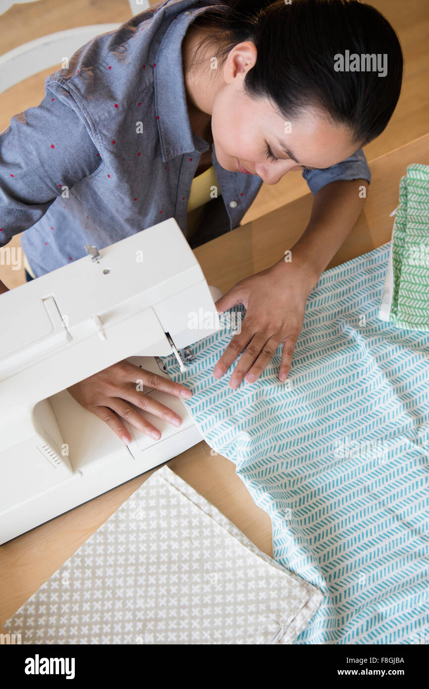 Chinese woman using sewing machine Stock Photo Alamy