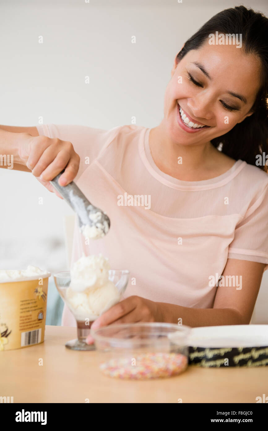 Chinese woman scooping ice cream Stock Photo