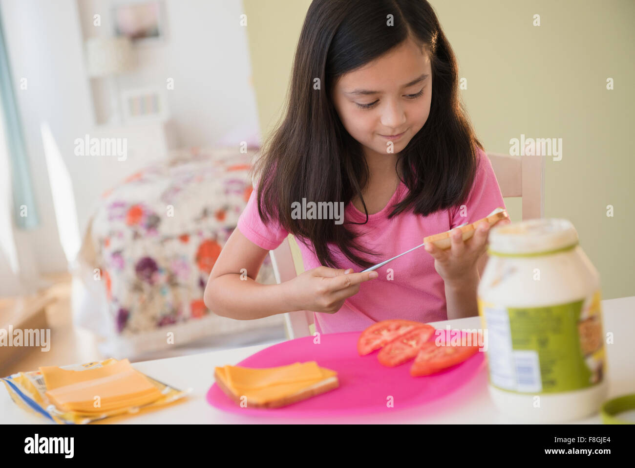 Girl making lunch sandwiches Stock Photo