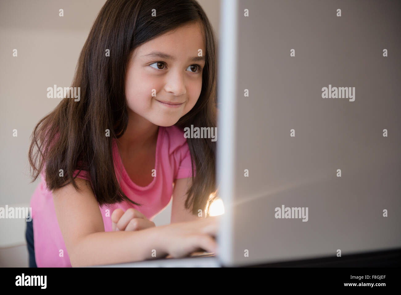 Smiling girl using laptop Stock Photo