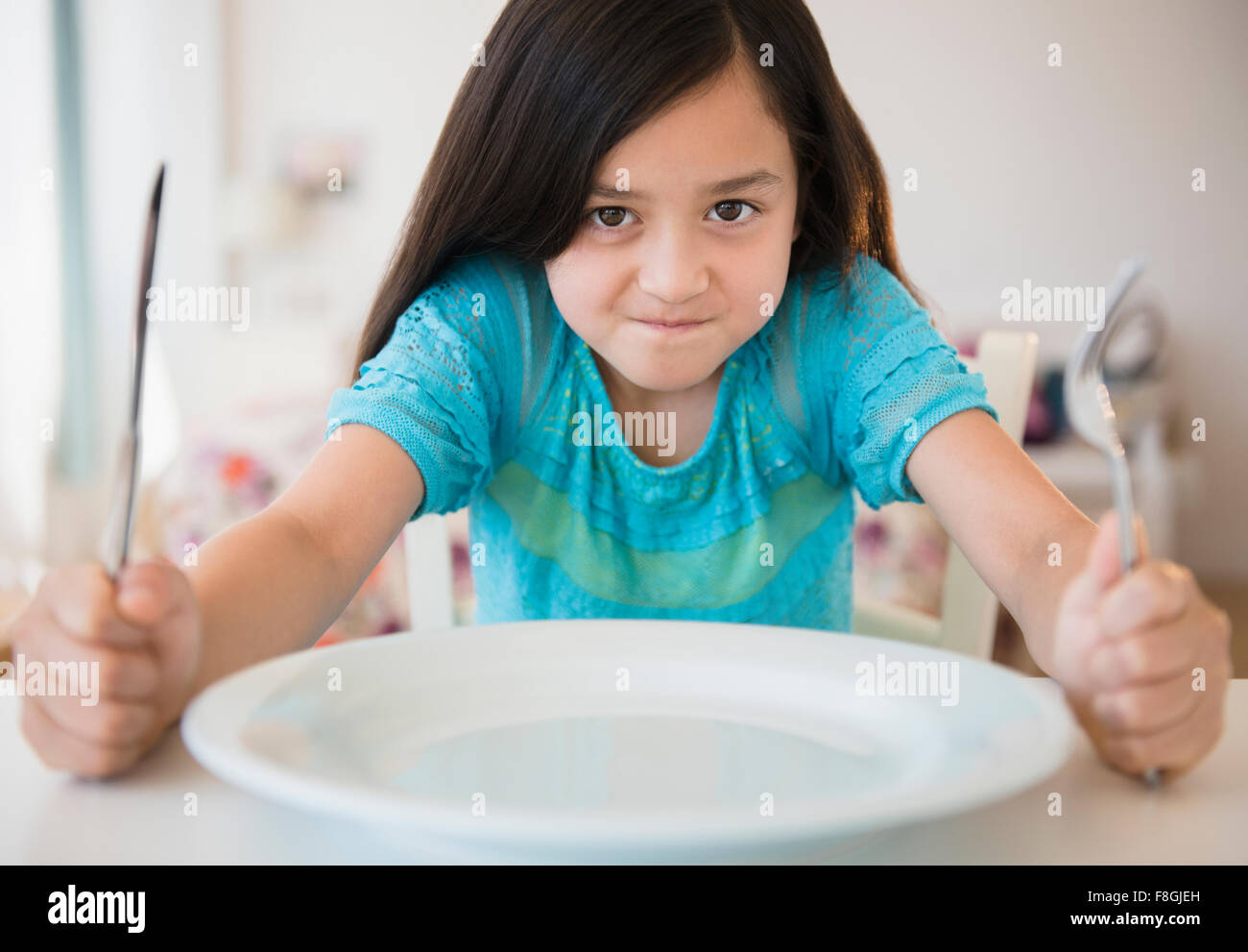 Hungry girl impatient for food Stock Photo