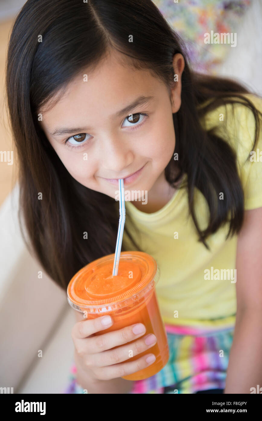 Girl drinking healthy carrot juice Stock Photo