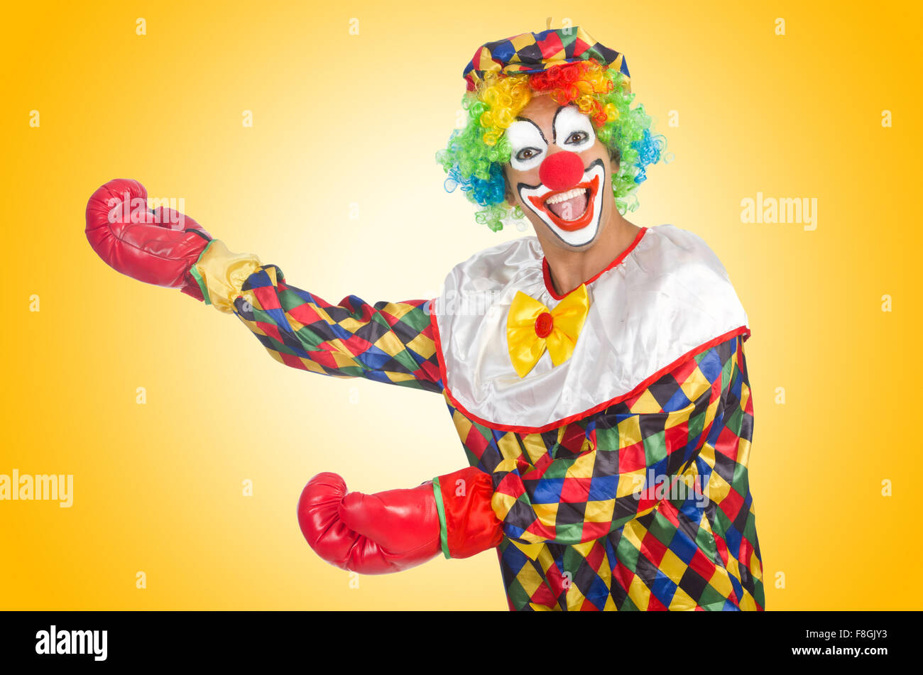 Clown with boxing gloves isolated on white Stock Photo - Alamy