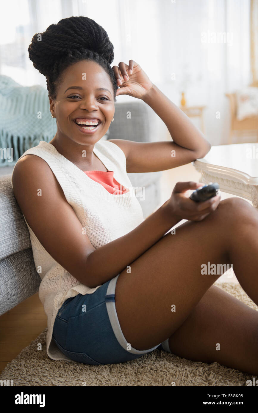 Black woman watching television Stock Photo