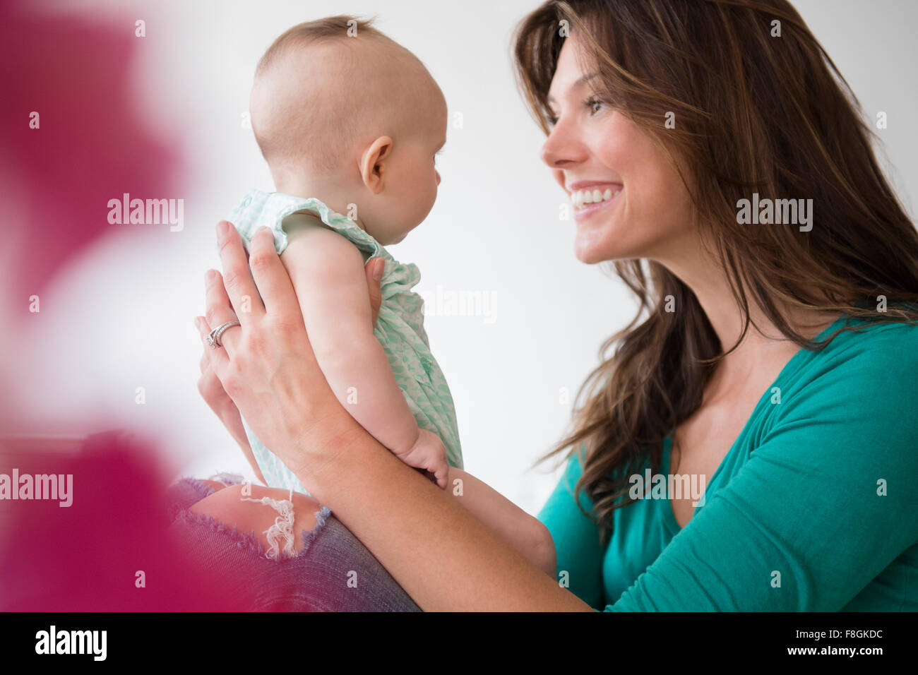 Mother holding baby daughter Stock Photo