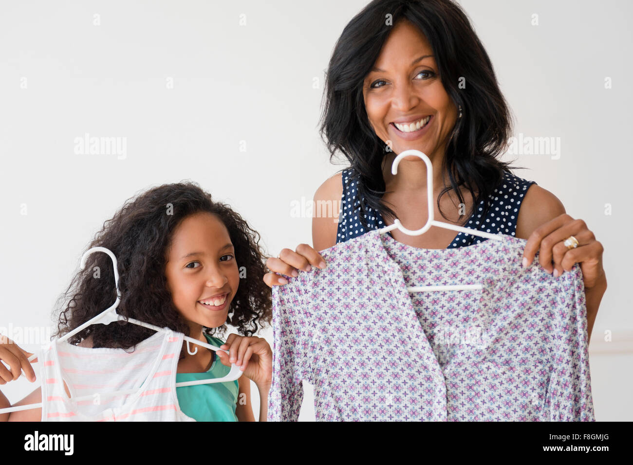 Mother and daughter displaying clothing Stock Photo