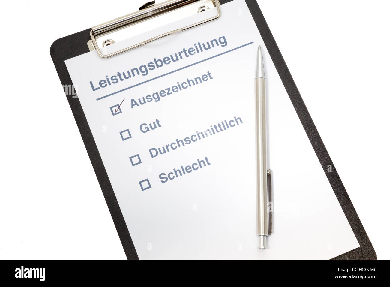 Performance evaluation paper with pen and tick marks on clipboard in german Stock Photo