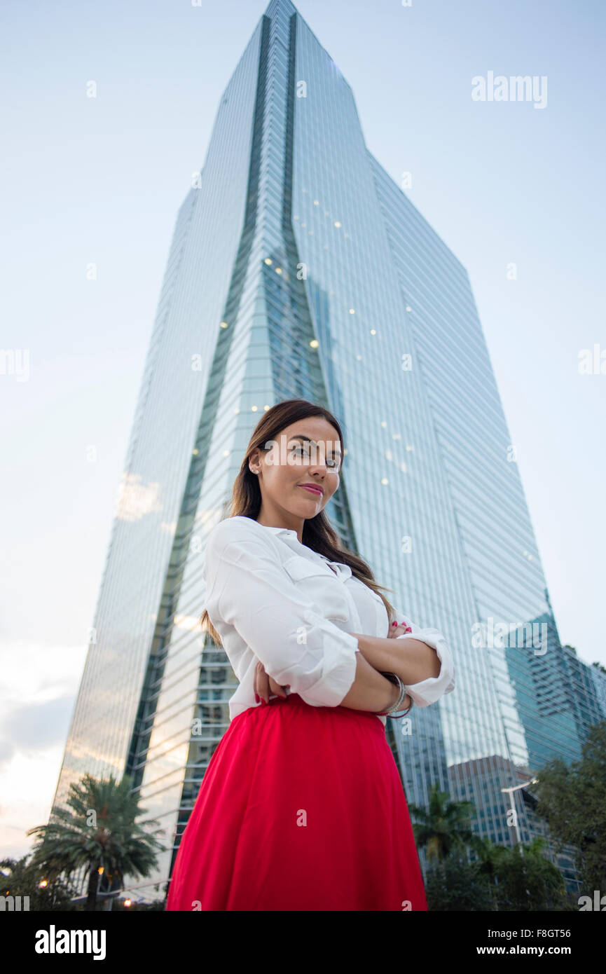 Hispanic businesswoman standing near highrise Stock Photo