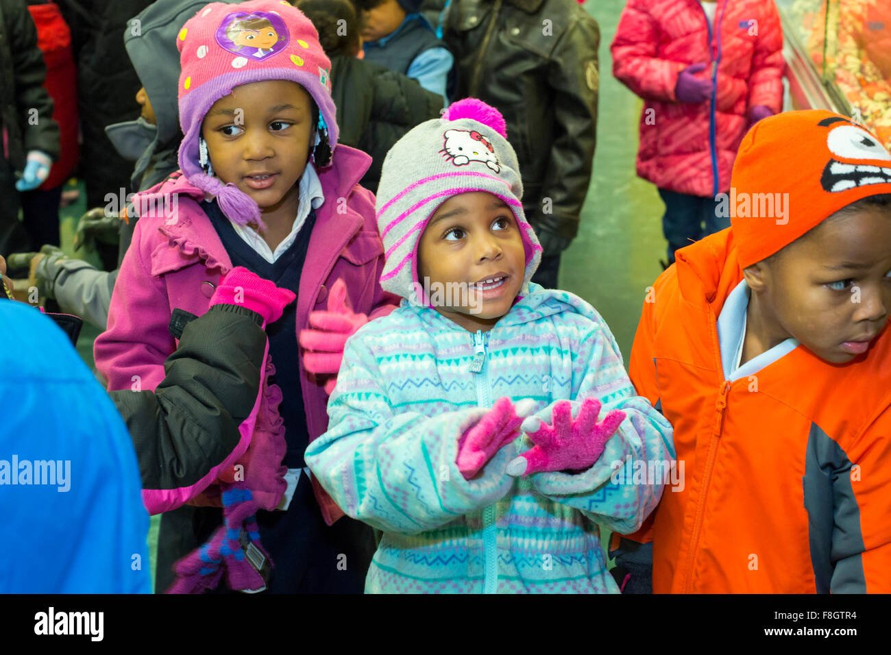 Detroit, Michigan USA. 9th December 2015. Children at Dossin Elementary School dressed to go outside to the playground wearing new mittens they have just received from a charity called Mittens for Detroit. The charity is distributing mittens to 26,000 Detroit Public Schools elementary students; most were donated by employees of Fiat Chrysler Automobiles. Credit:  Jim West/Alamy Live News Stock Photo