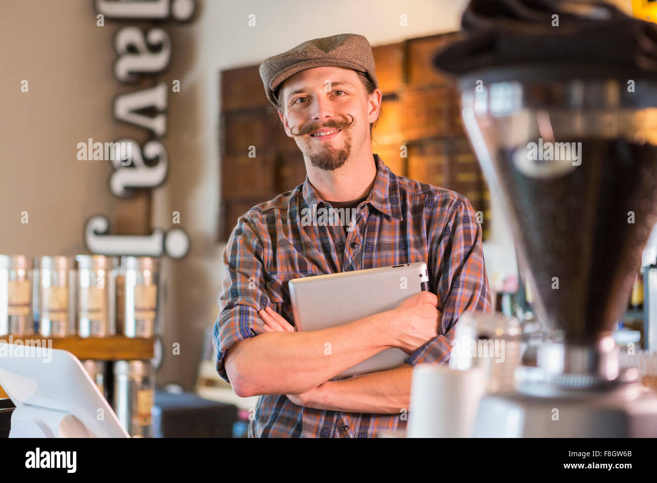 Caucasian barista holding digital tablet in cafe Stock Photo