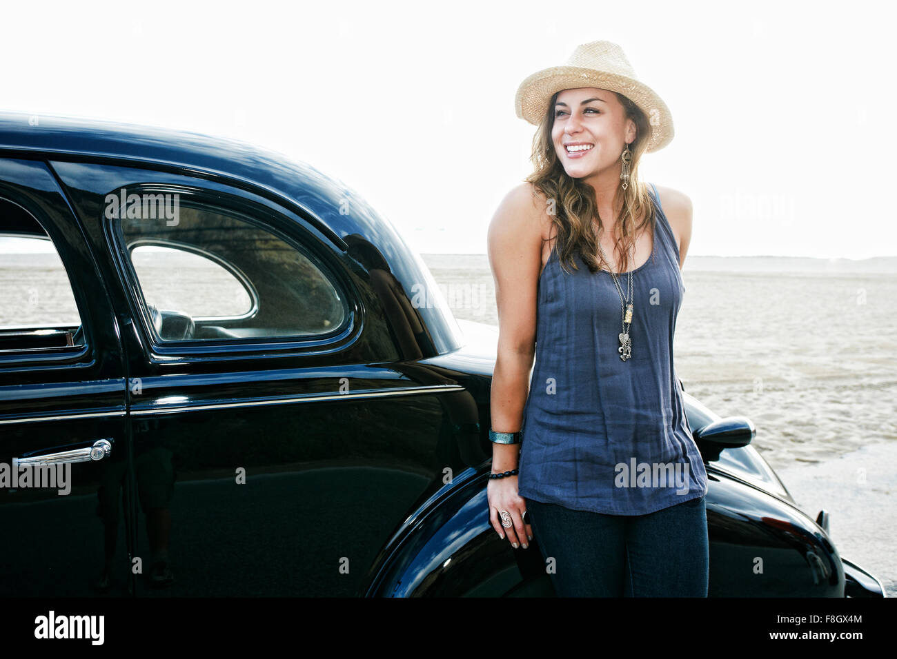 Woman standing near vintage car Stock Photo