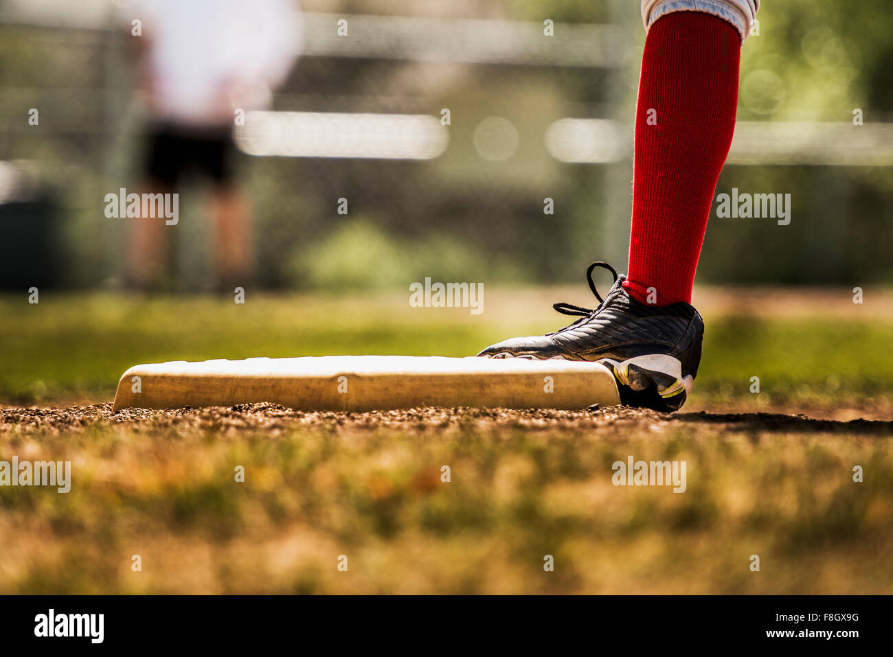 Baseball player touching base Stock Photo