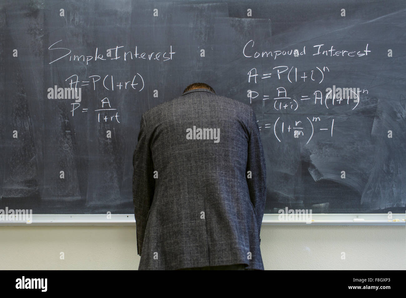 Caucasian teacher frustrated at chalkboard Stock Photo