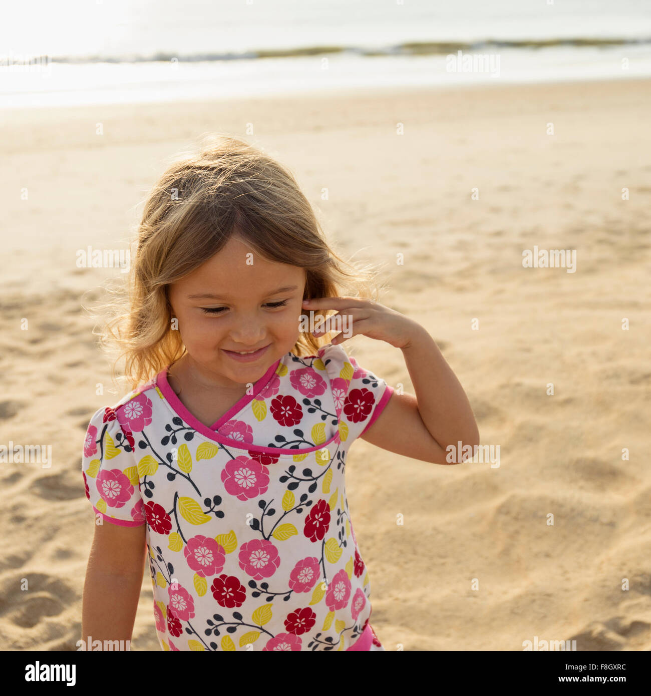 Mixed race girl smiling on beach Stock Photo Alamy