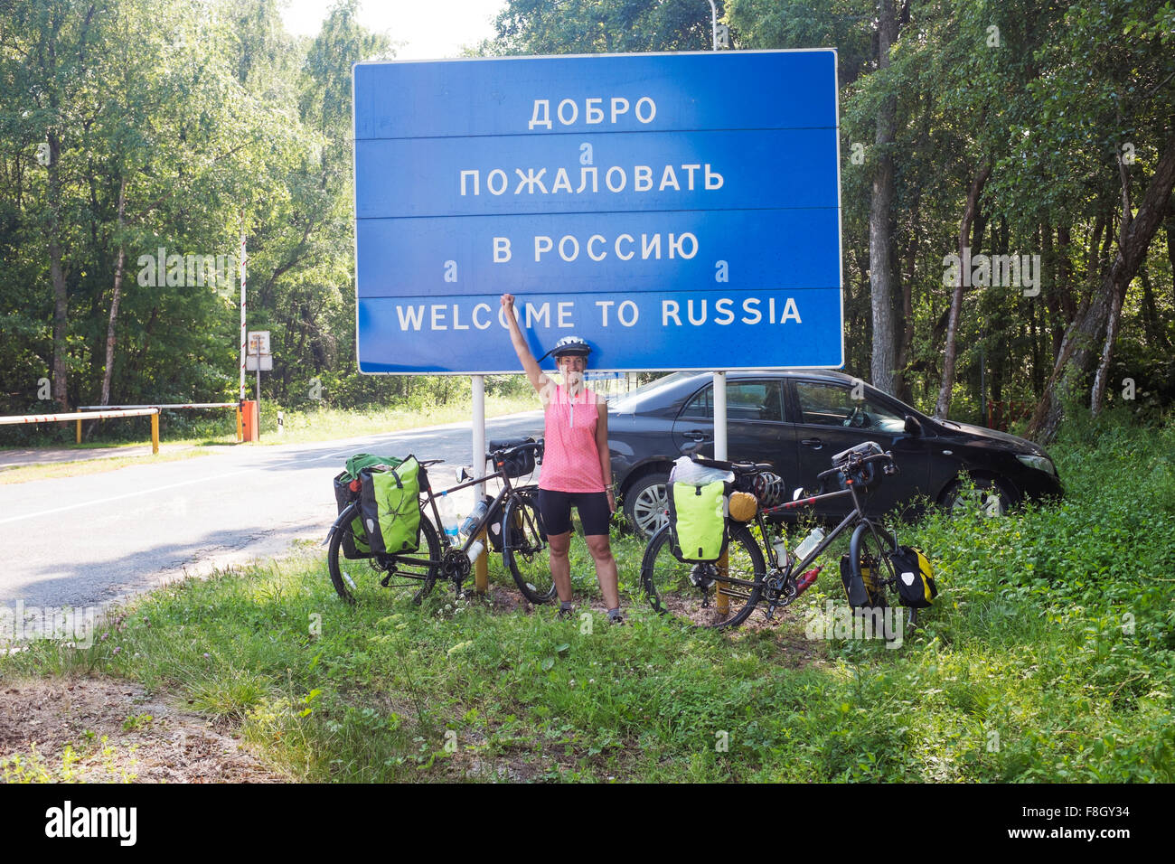 Hispanic biker cheering at Russian border Stock Photo