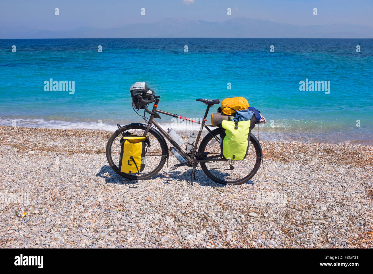 Bicycle parked on rocky beach Stock Photo