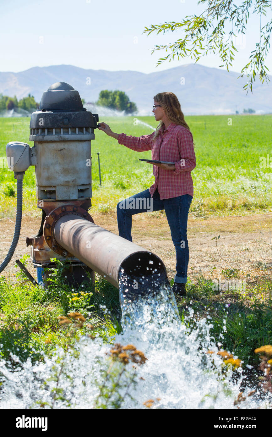 Caucasian farmer checking water pump Stock Photo