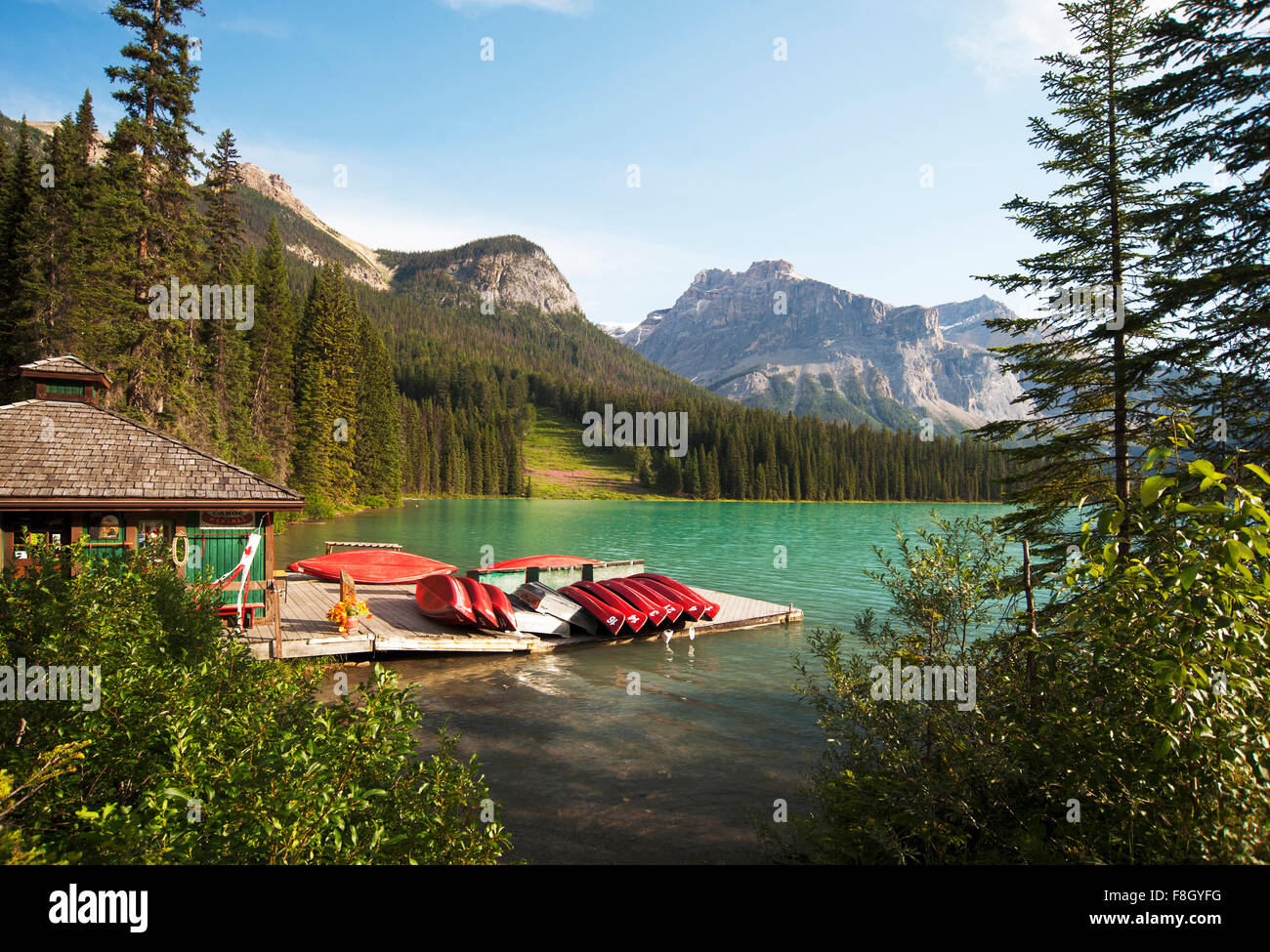Canoes on wooden dock in rural lake Stock Photo