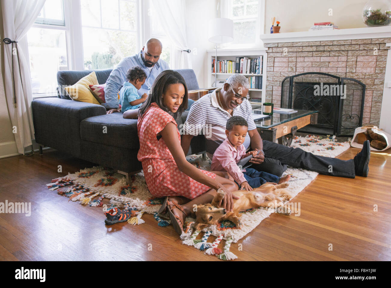 African American family relaxing in living room Stock Photo