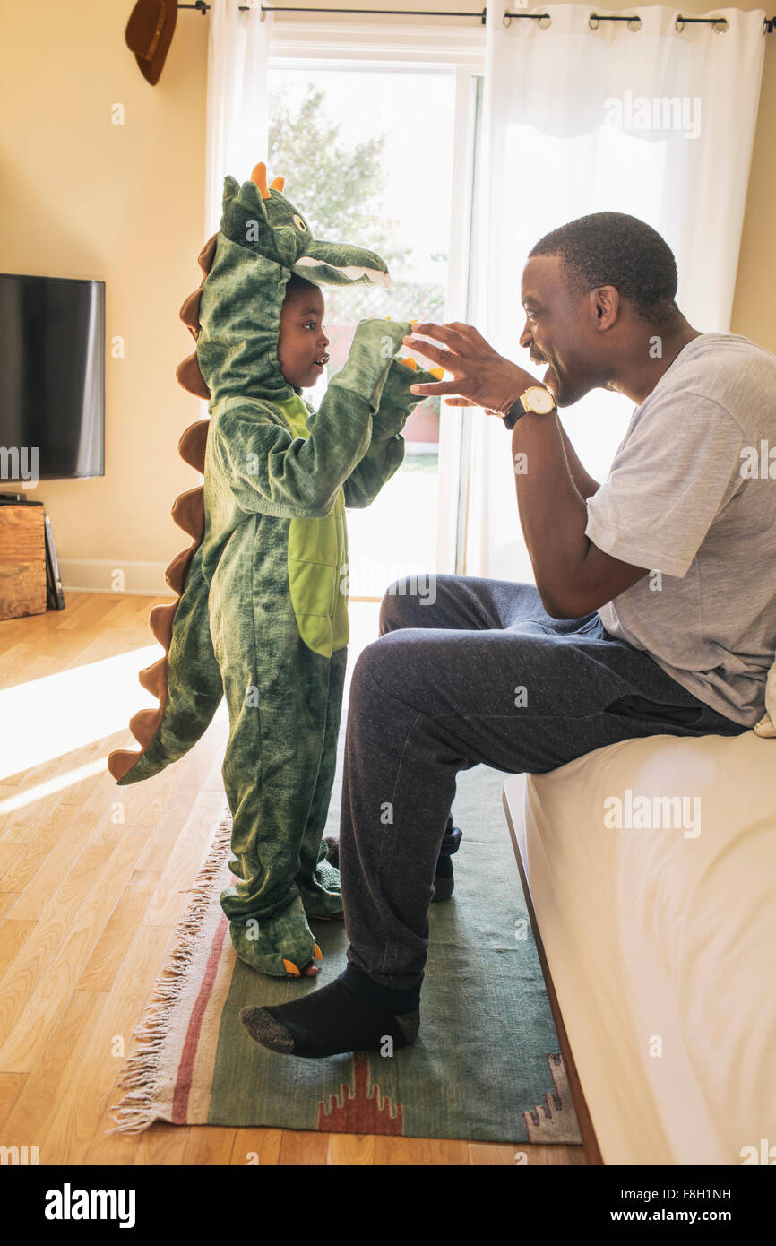 African American father playing with daughter in costume Stock Photo