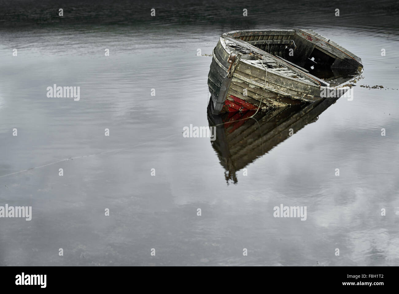 Dilapidated boat in lake Stock Photo