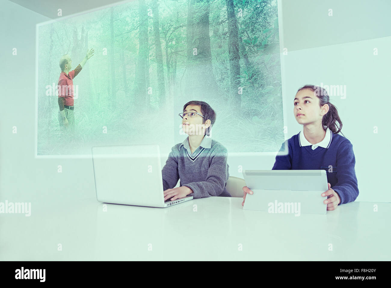 Children watching floating screen in online class Stock Photo