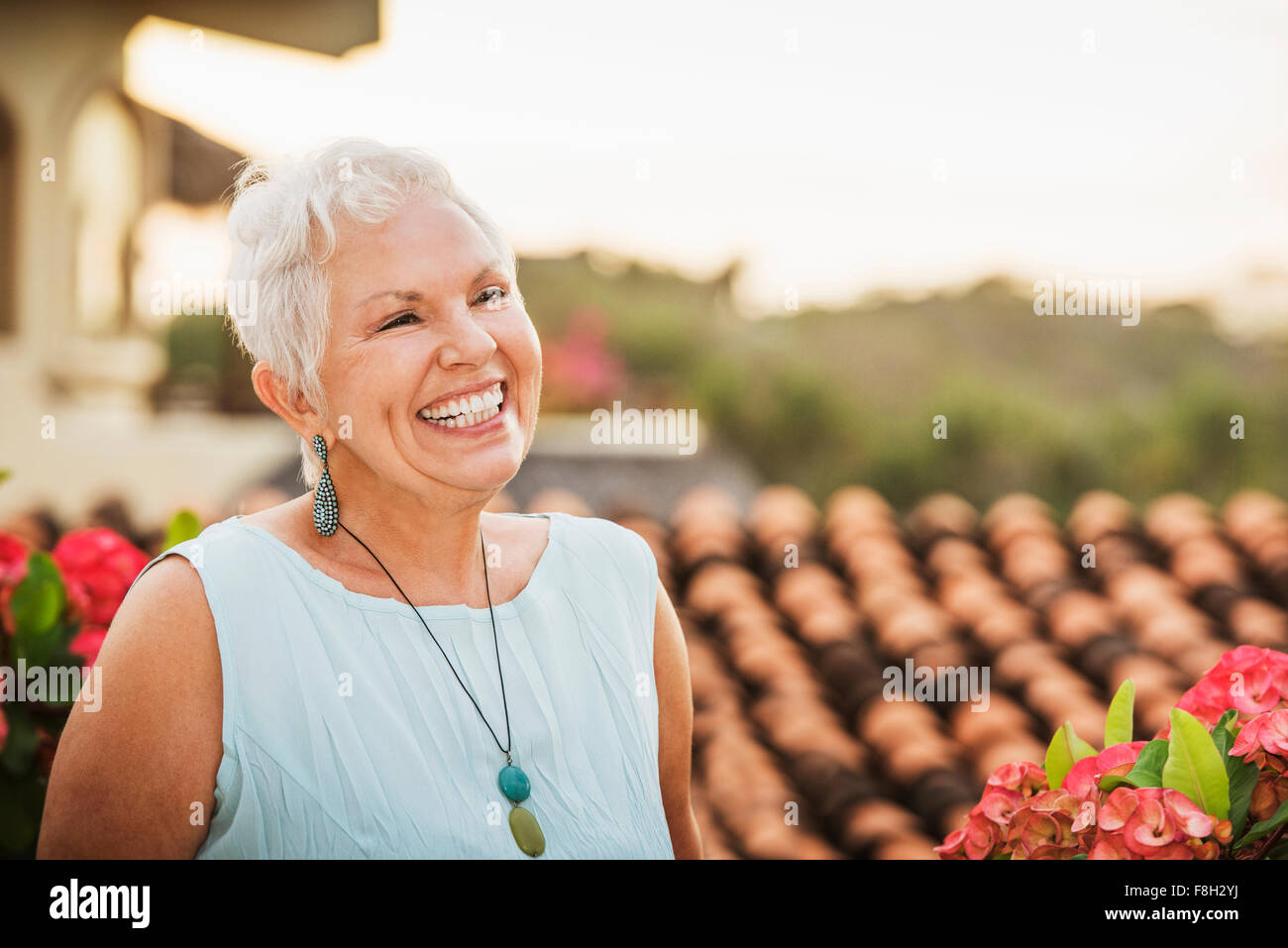 Woman laughing outdoors Stock Photo