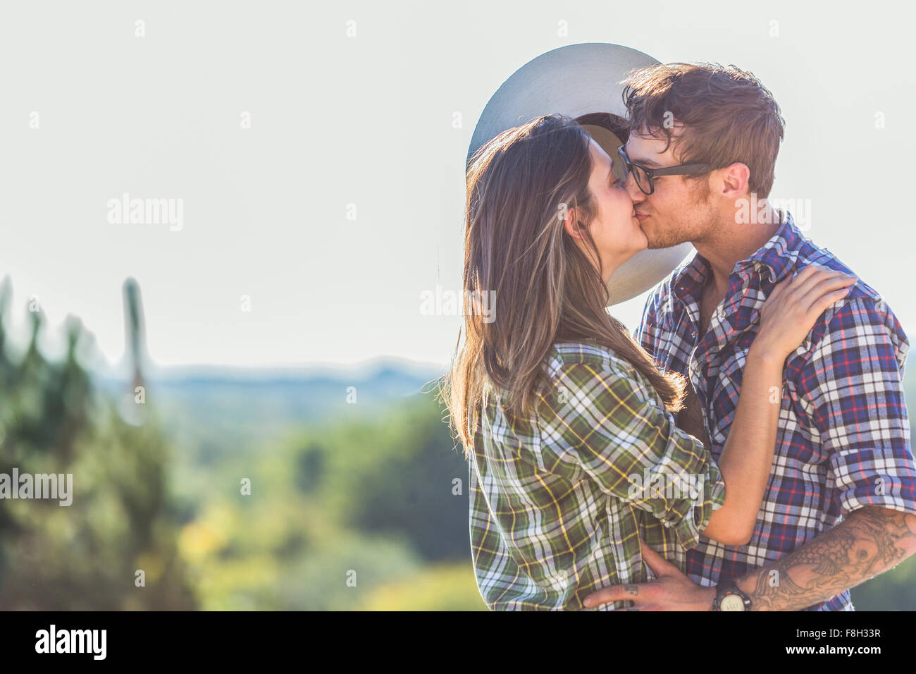 Caucasian couple kissing outdoors Stock Photo