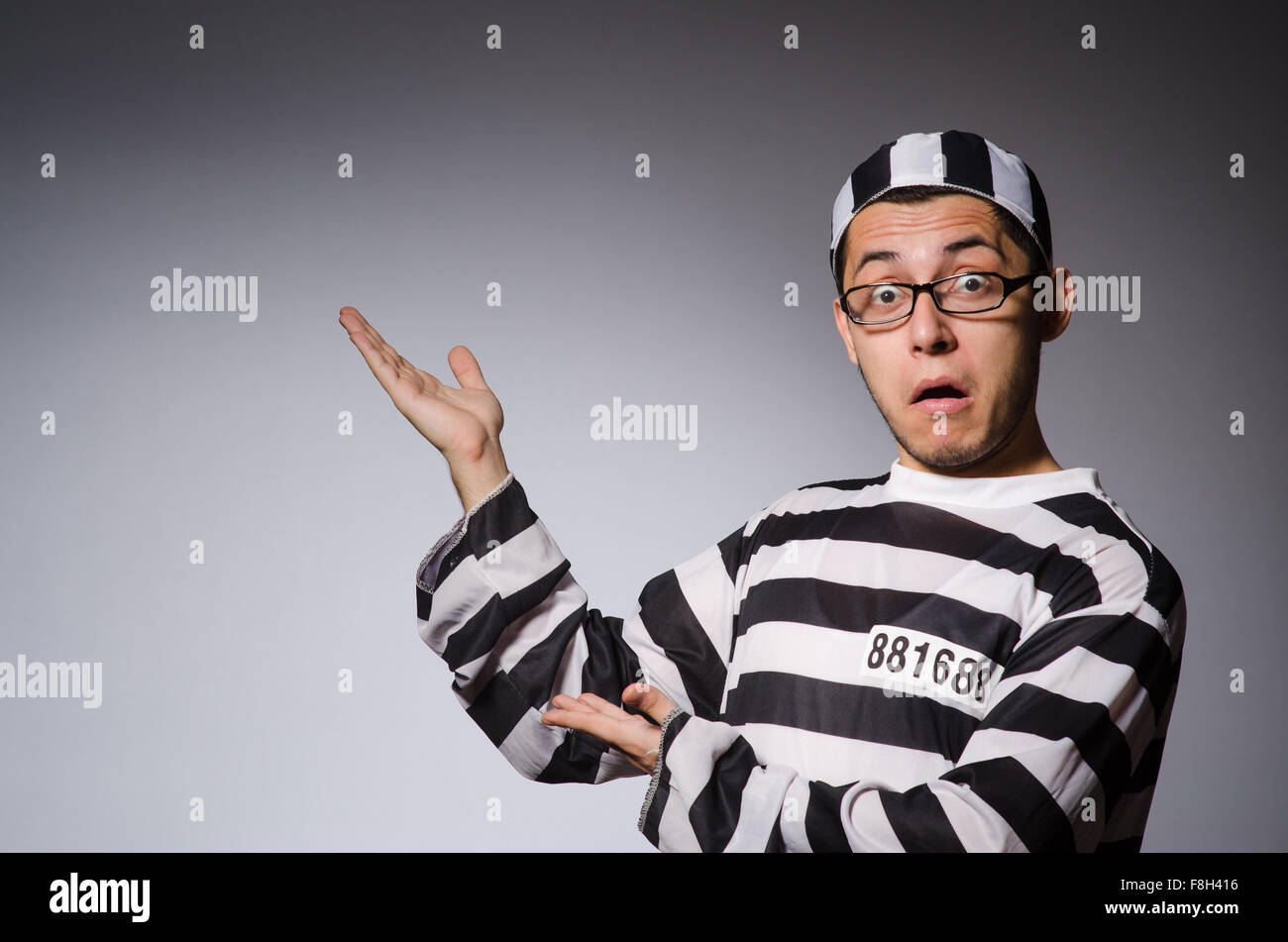 Funny prisoner isolated on gray Stock Photo Alamy