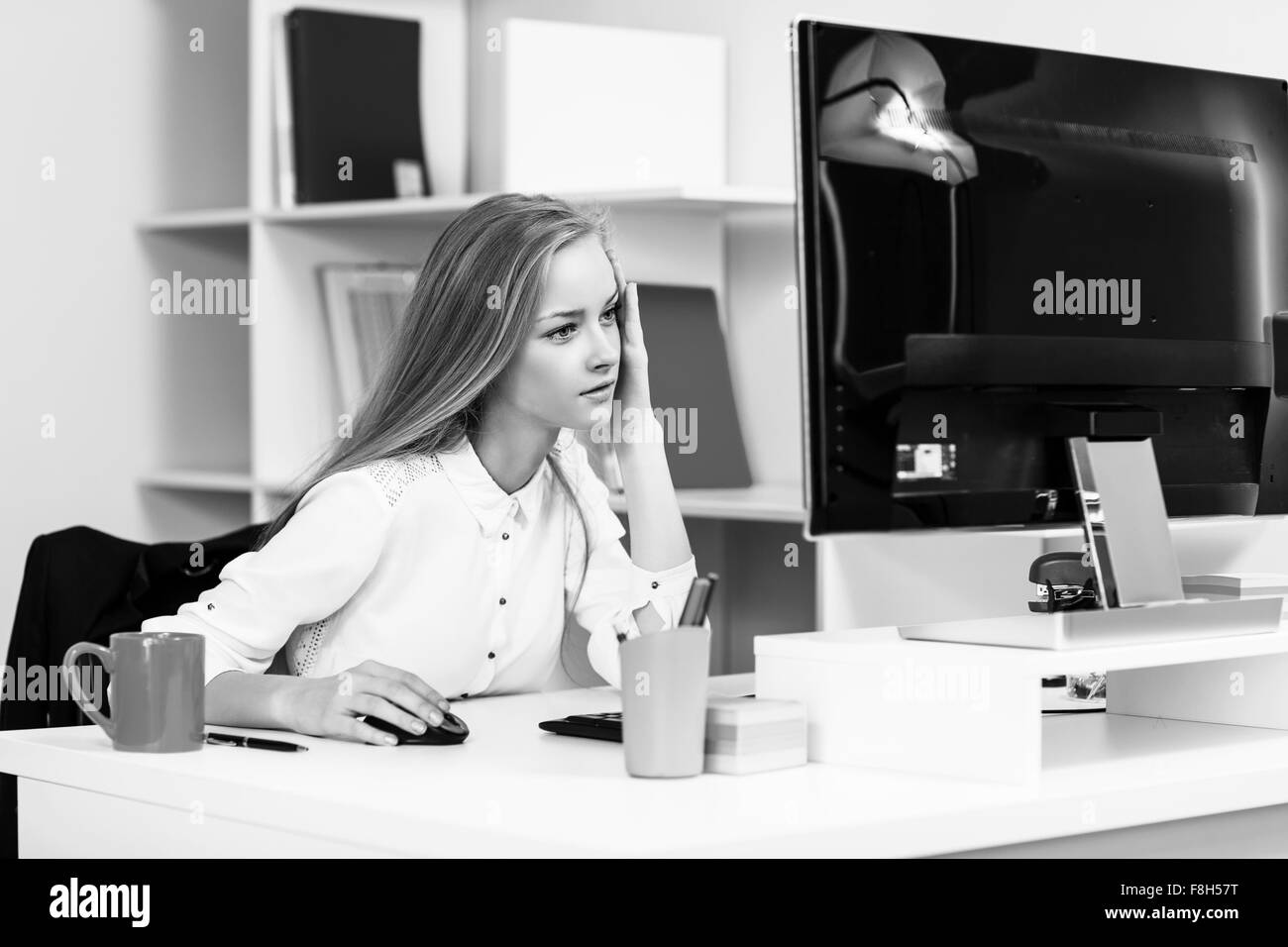 Woman sitting at the desk  with computer Stock Photo