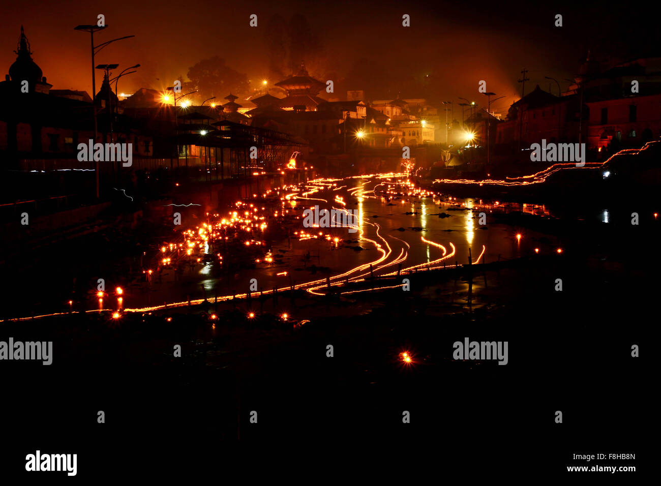 Kathmandu, Nepal. 10th Dec, 2015. Photo captured in long exposure shows oil lamp on the Bagmati river during the Bala Chaturdashi Festival in Kathmandu, Nepal, Dec. 10, 2015. On this day, worshippers scatter seven types of grain known as 'Sat biu' honouring the departed along a route at Pashupatinath temple. © Pratap Thapa/Xinhua/Alamy Live News Stock Photo