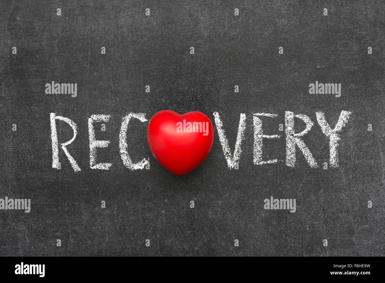 recovery word handwritten on blackboard with heart symbol instead of O Stock Photo
