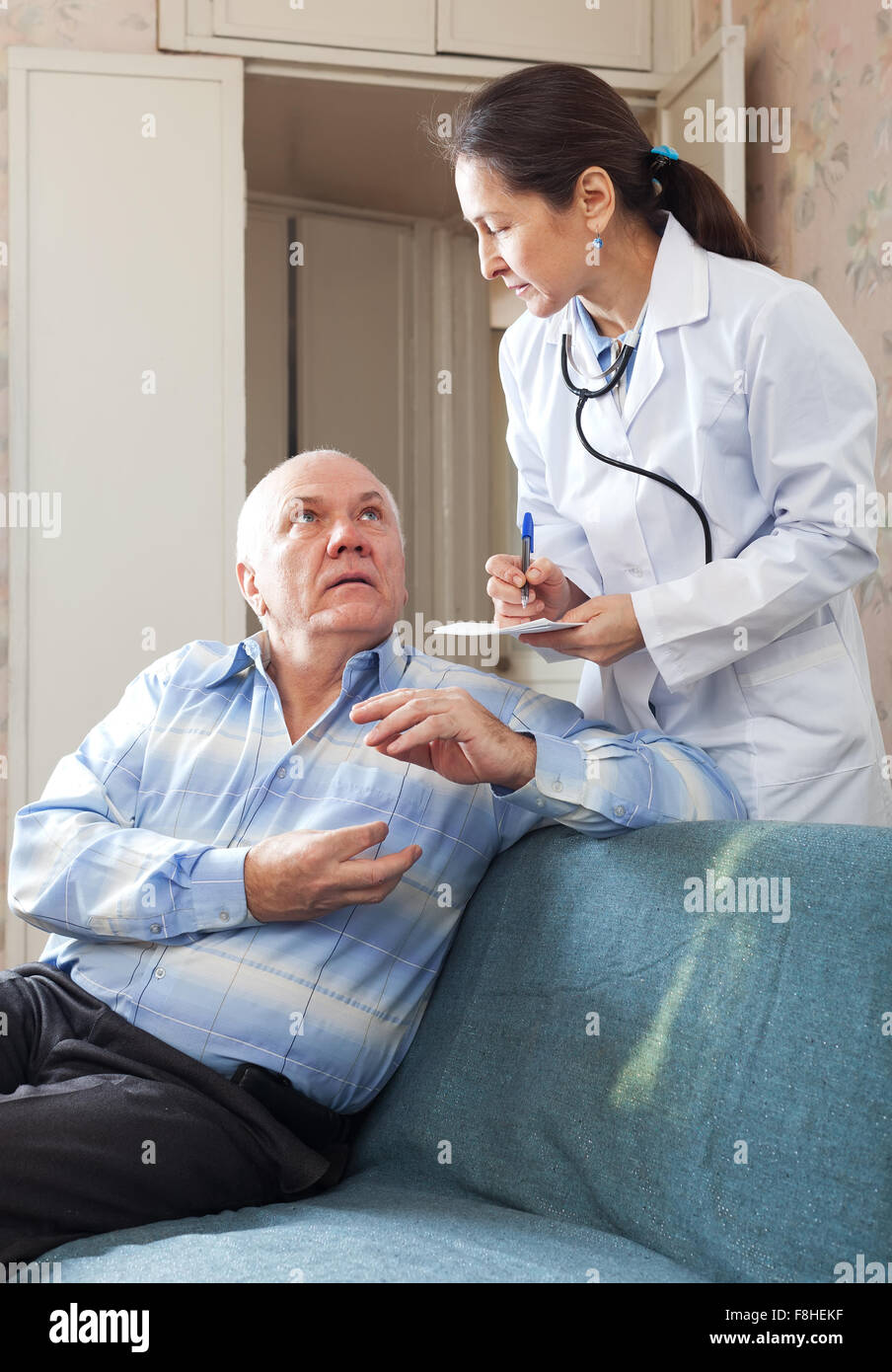 Friendly doctor asked senior patient feels Stock Photo - Alamy