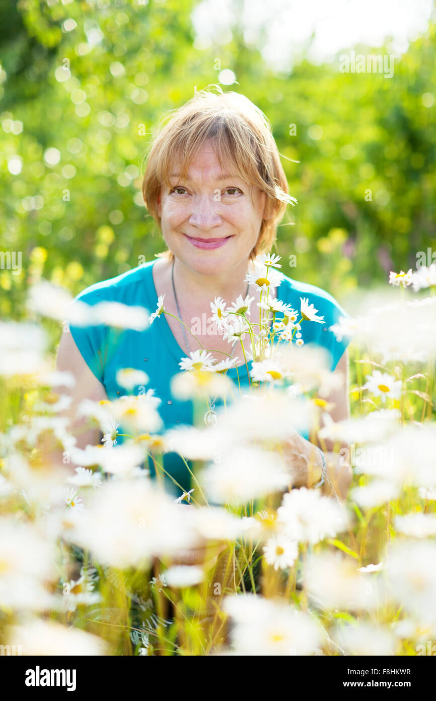 mature woman daisy field in summer Stock Photo Alamy
