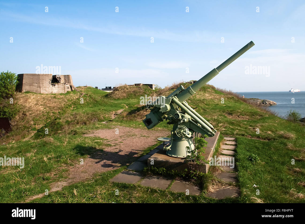 Anti-aircraft gun in the background of blue sea in Scandinavia Stock Photo