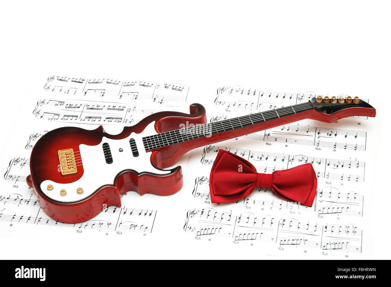 Musical notes, guitar and bow tie on white Stock Photo Alamy