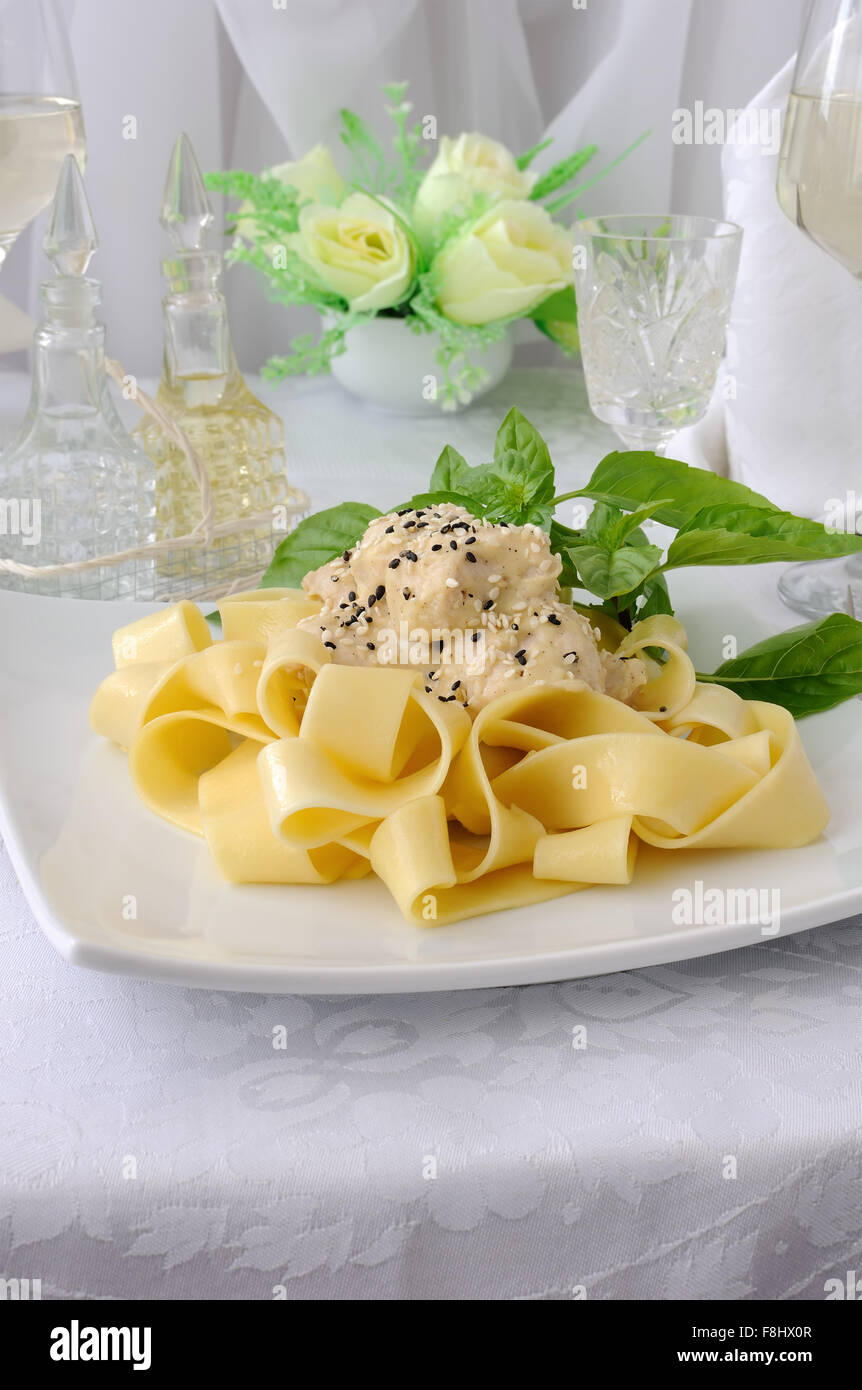 Italian pasta - Pappardelle with chicken fillet in a creamy sauce with sesame seeds Stock Photo
