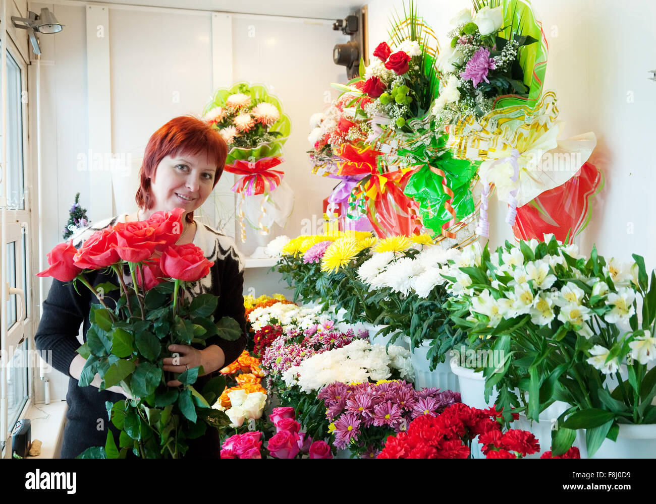 Middle-aged woman in flower shop Stock Photo - Alamy