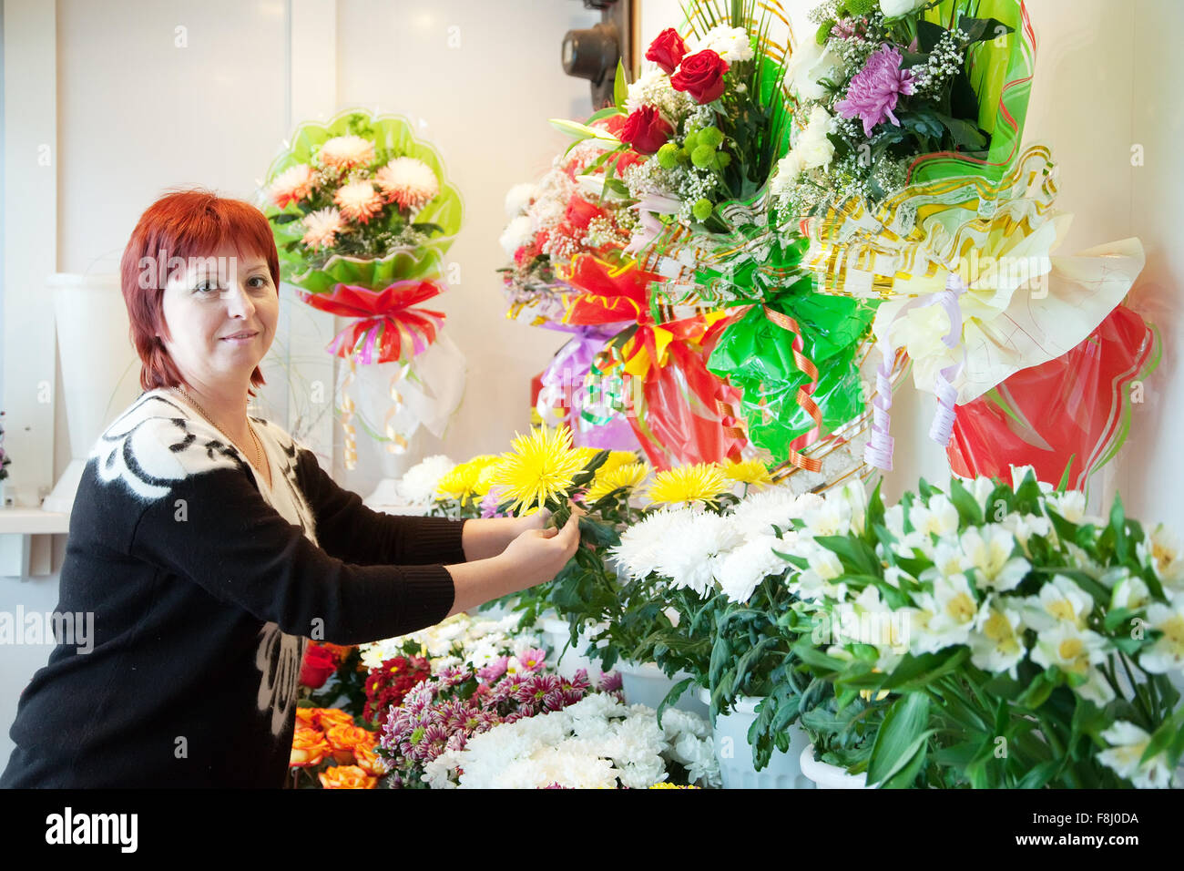 Middle-aged woman in flower shop Stock Photo - Alamy