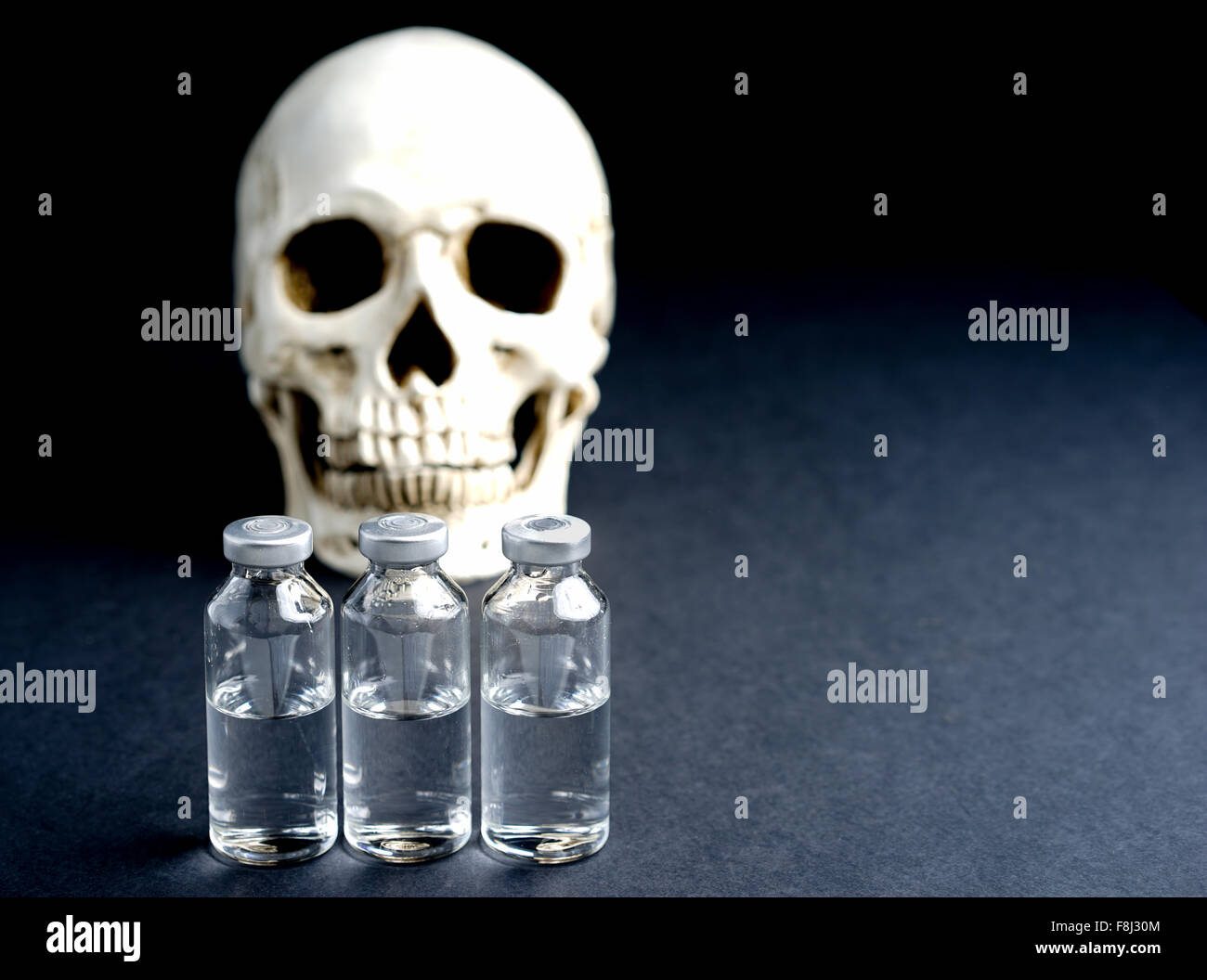 Skull and medical vials risk of death or abuse Stock Photo