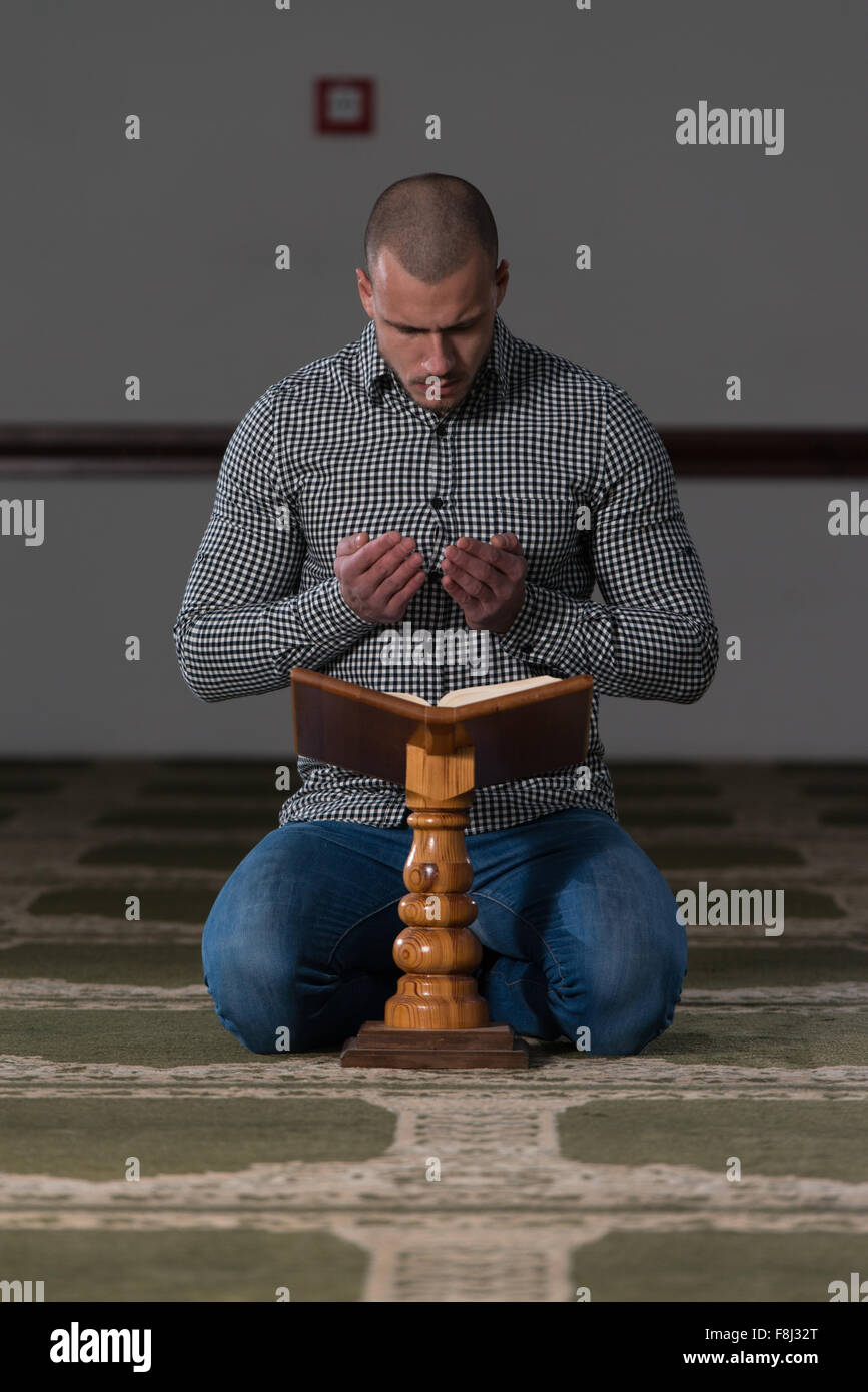 Muslim Man Is Reading The Koran Stock Photo